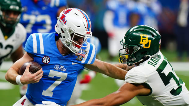 Jan 1, 2022; New Orleans, LA, USA; Mississippi Rebels quarterback Luke Altmyer (7) runs with the ball against Baylor Bears linebacker Garmon Randolph (55) during the first half in the 2022 Sugar Bowl at Caesars Superdome. Mandatory Credit: John David Mercer-USA TODAY Sports
